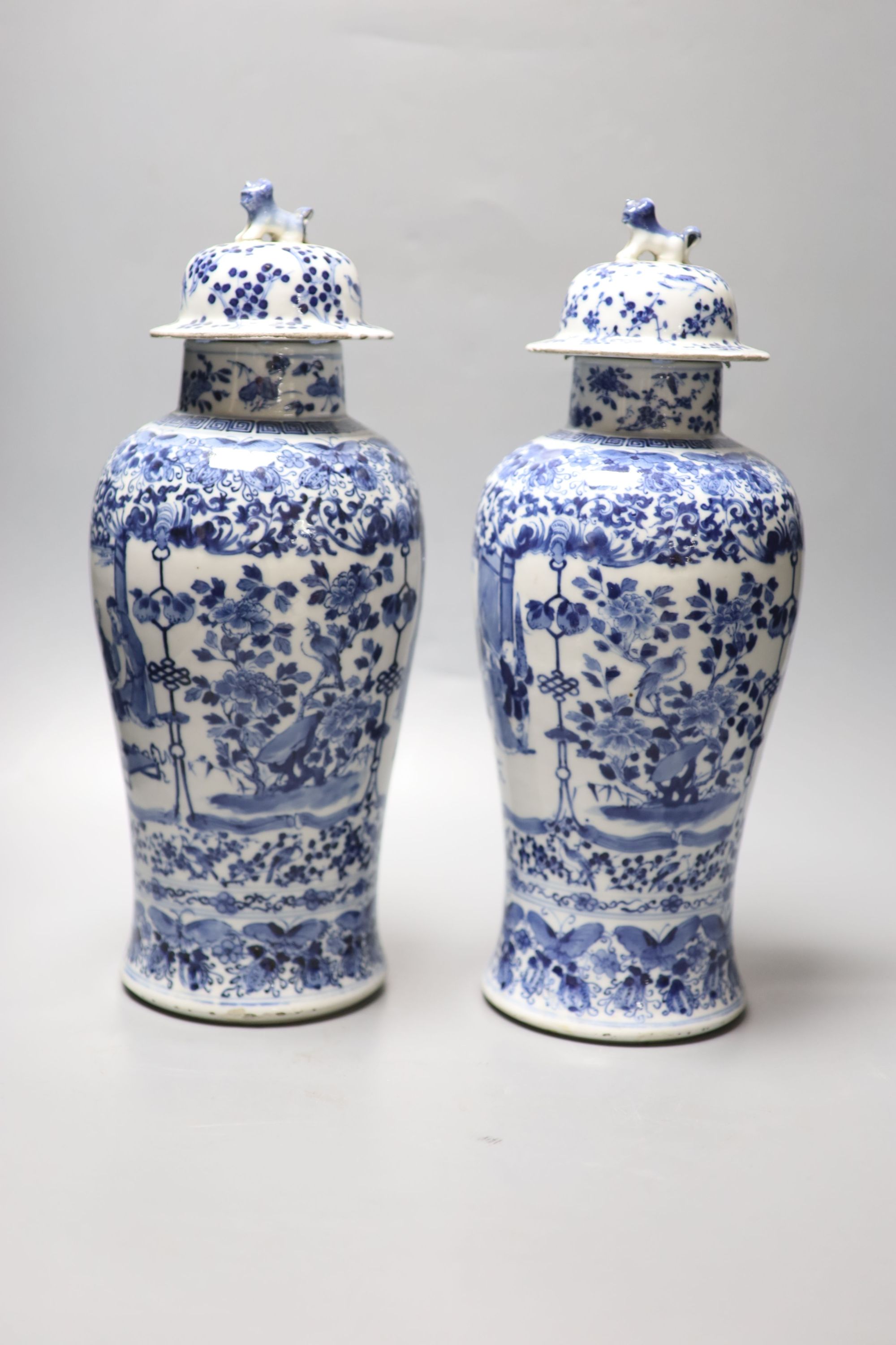 A pair of Chinese blue and white baluster vases and covers, Kangxi marks, late 19th century, 39.5cm high